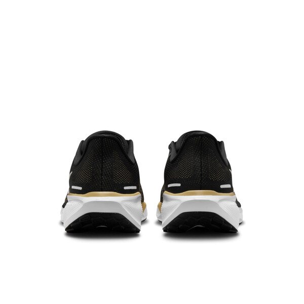 Back view of black Nike Air Zoom running shoes with white midsoles, gold heel accents, and black outsoles